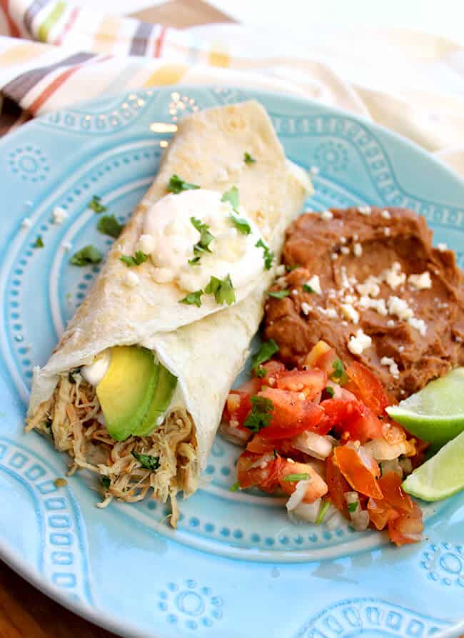 Easy Crockpot Chicken Verde Burritos It's one of the easiest dinners to prepare... and it's seriously so yummy. #crockpot #chicken #recipe