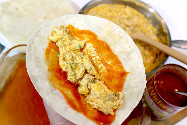 adding the filling to the enchilada tortilla