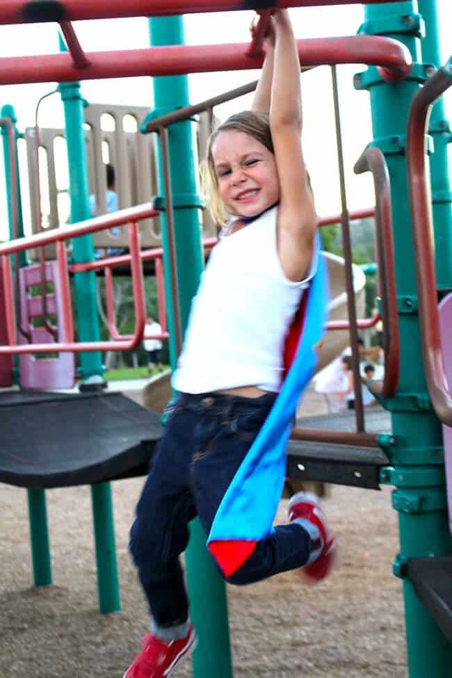 Little Boy Swinging on the Monkey Bars