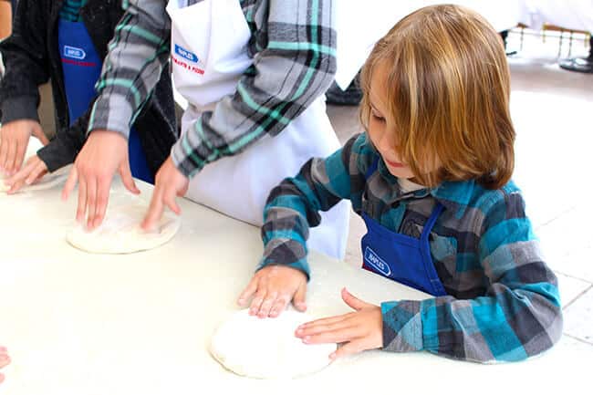 Vann making a pizza